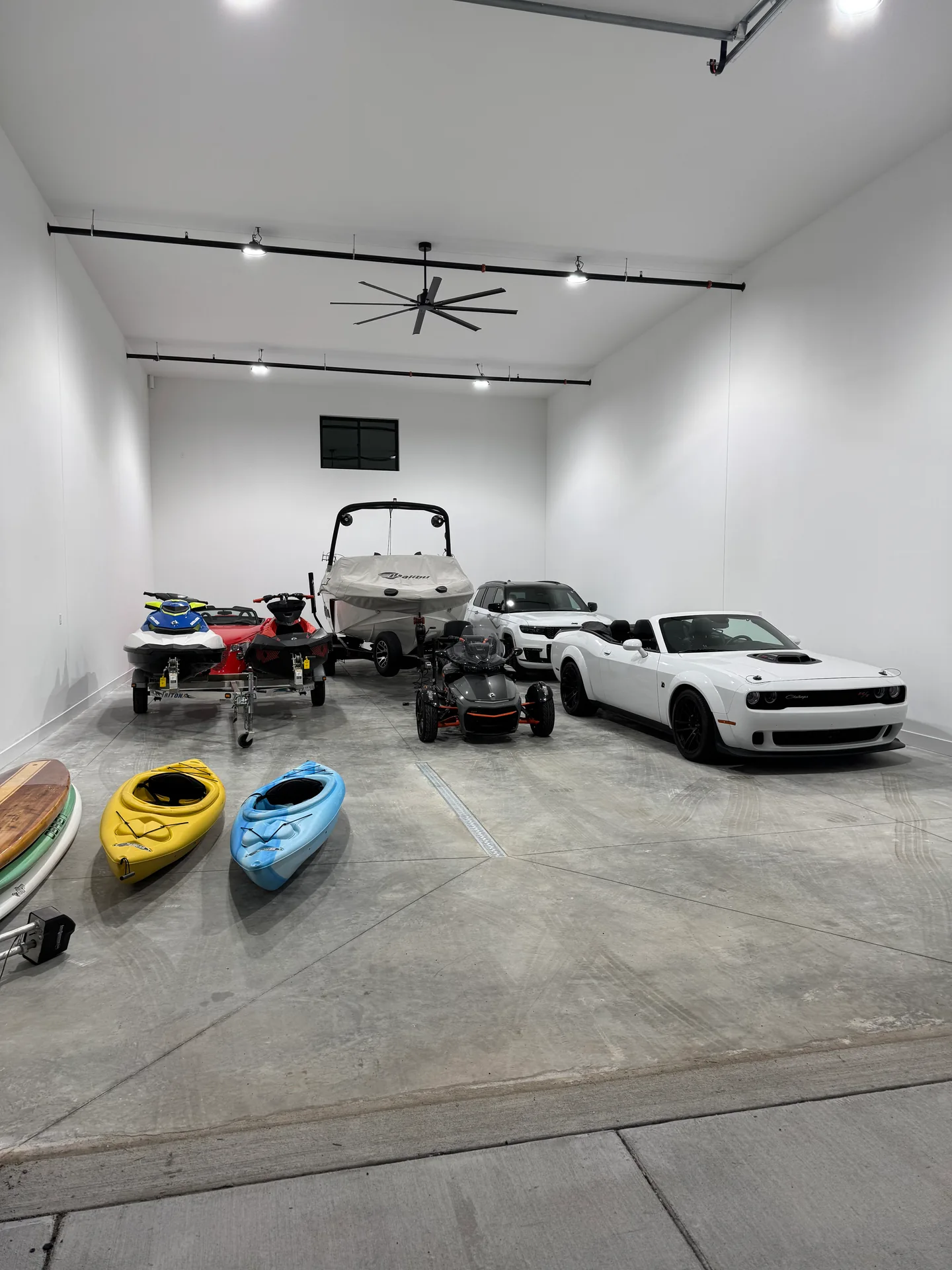 Garage holding a boat, personal watercraft, vehicles and kayaks